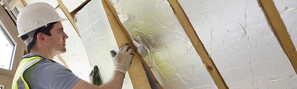 photo of worker installing insulation